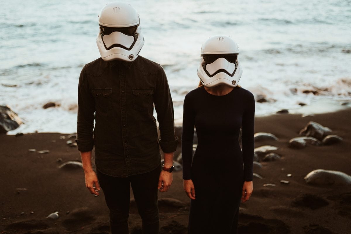 A couple wearing Stormtrooper helmets