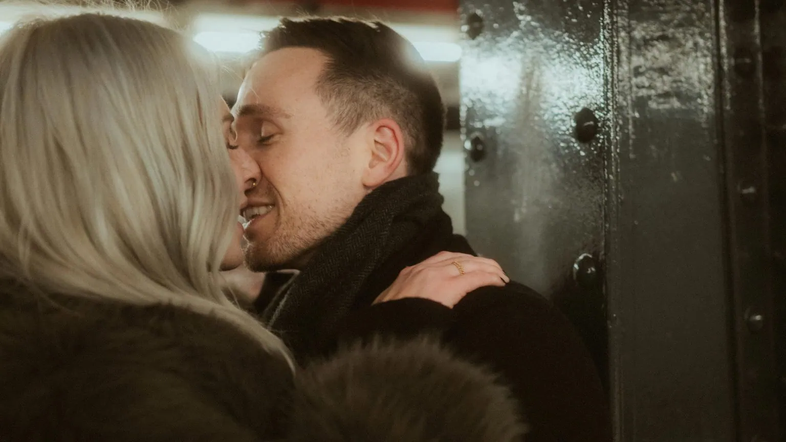 a man and woman kissing