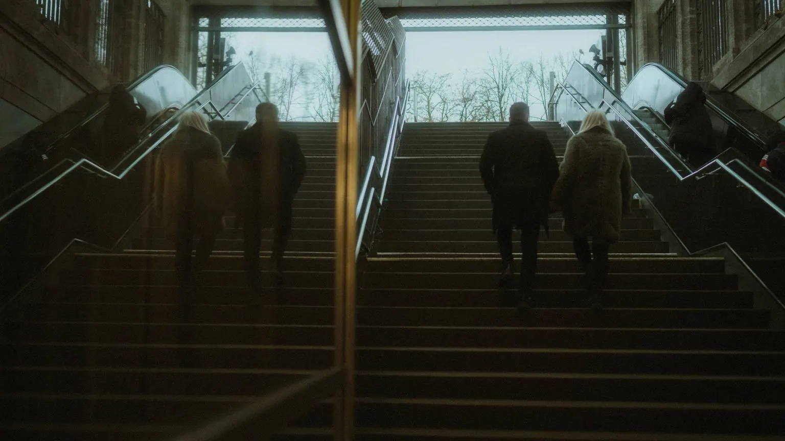 a couple walking up stairs in the St. Pauli subway station