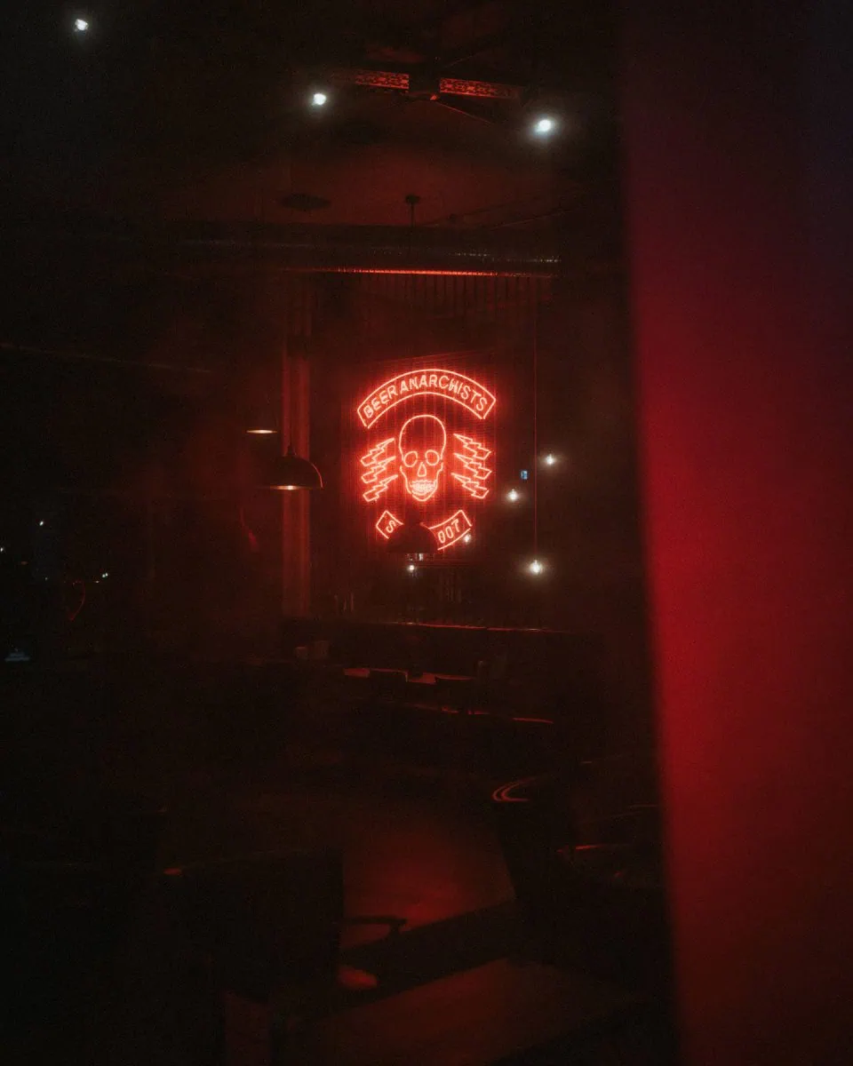 a red neon sign in a dark room