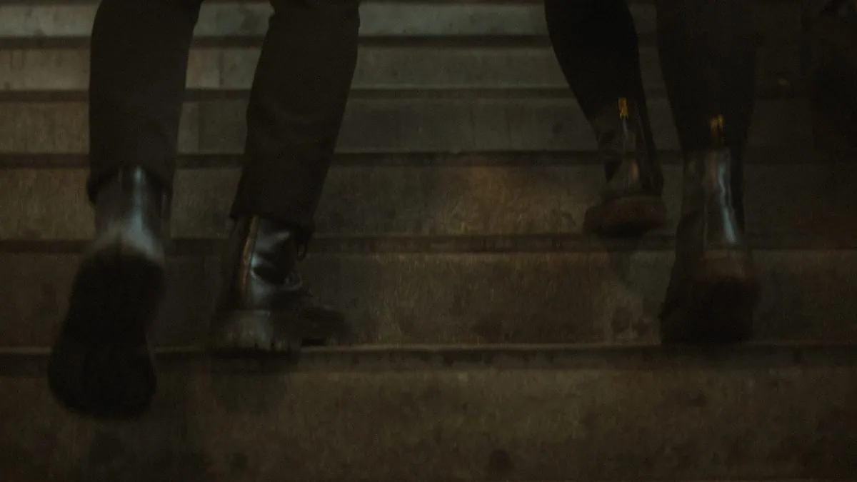 a person's legs on a set of stairs